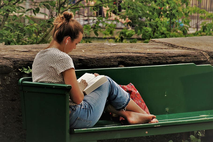 woman, blue, denim pants reading book, green, bench, daytime, reading, student, science, wisdom