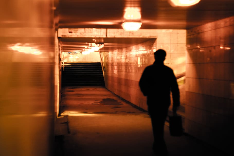 people, man, alone, walking, building, light, alley, underground, silhouette, illuminated