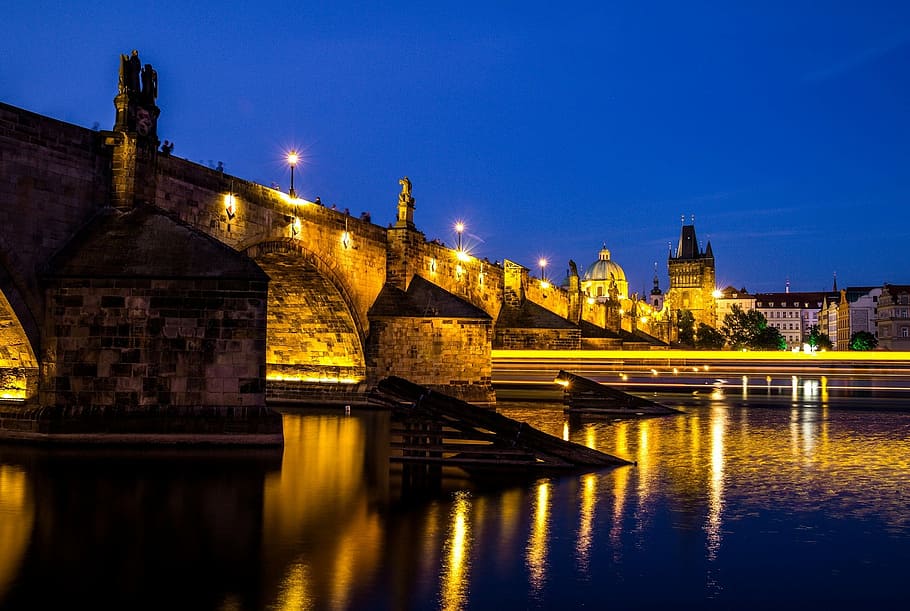 low-angle photography, building, body, water, charles bridge, night, vltava river, prague, czech republic, pedestrian