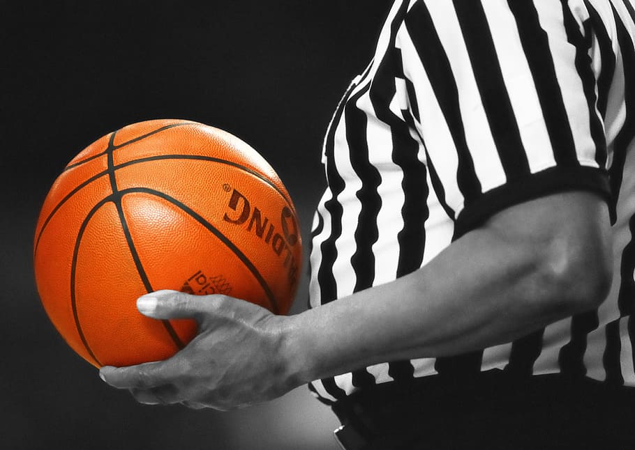 man, white, black, striped, shirt, holding, orange, spalding basketball, basketball, referee