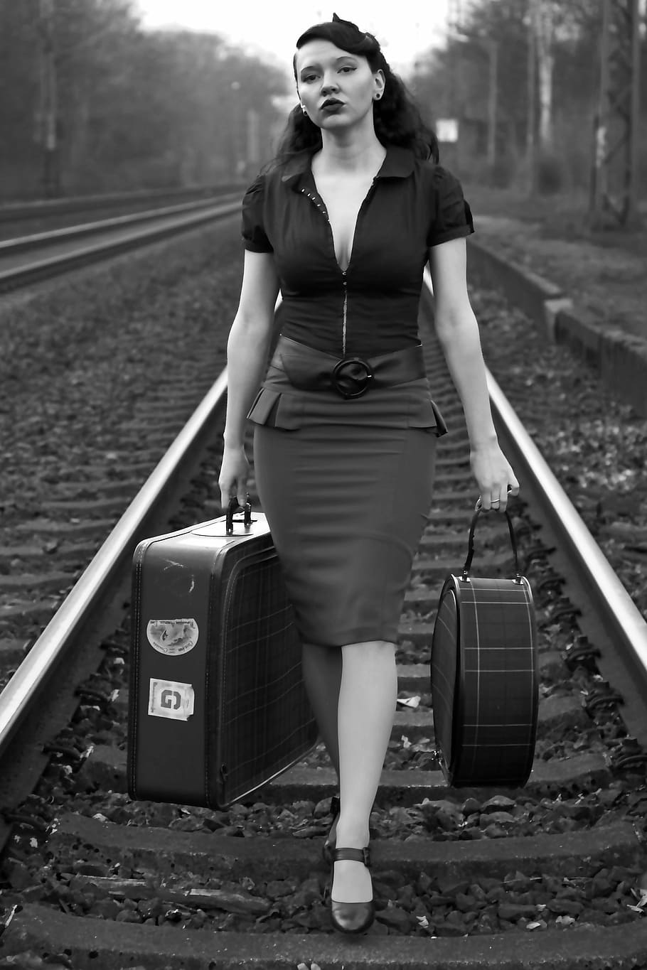greyscale portrait photograph, woman, carrying, two, luggages, pin-up, black and white, retro, nostalgic, retro photo