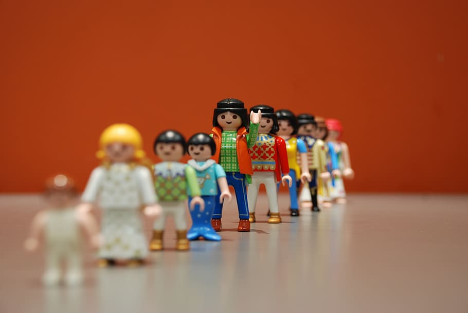 assorted plastic figures, row, playmobil, waving, indoors, group of people, figurine, table, toy, human representation