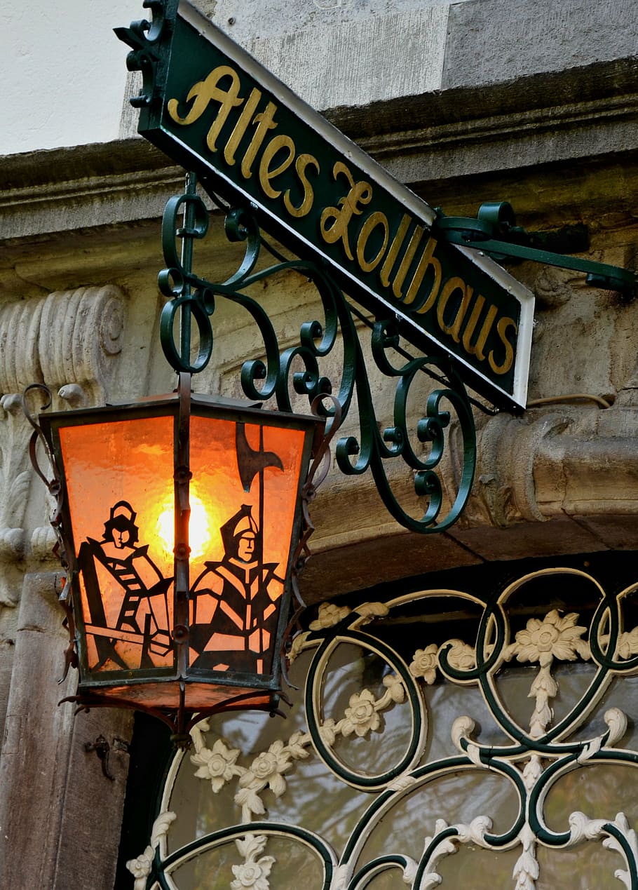 green, yellow, steel altes lollhaus signage, hanging, lamp, street lamp, lantern, historic street lighting, light, architecture