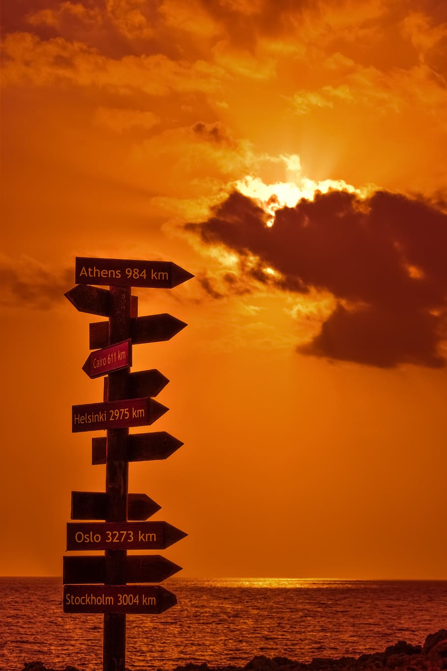 signposts, signs, distance from, sunset, orange, sea, sky, clouds, horizon, sunlight
