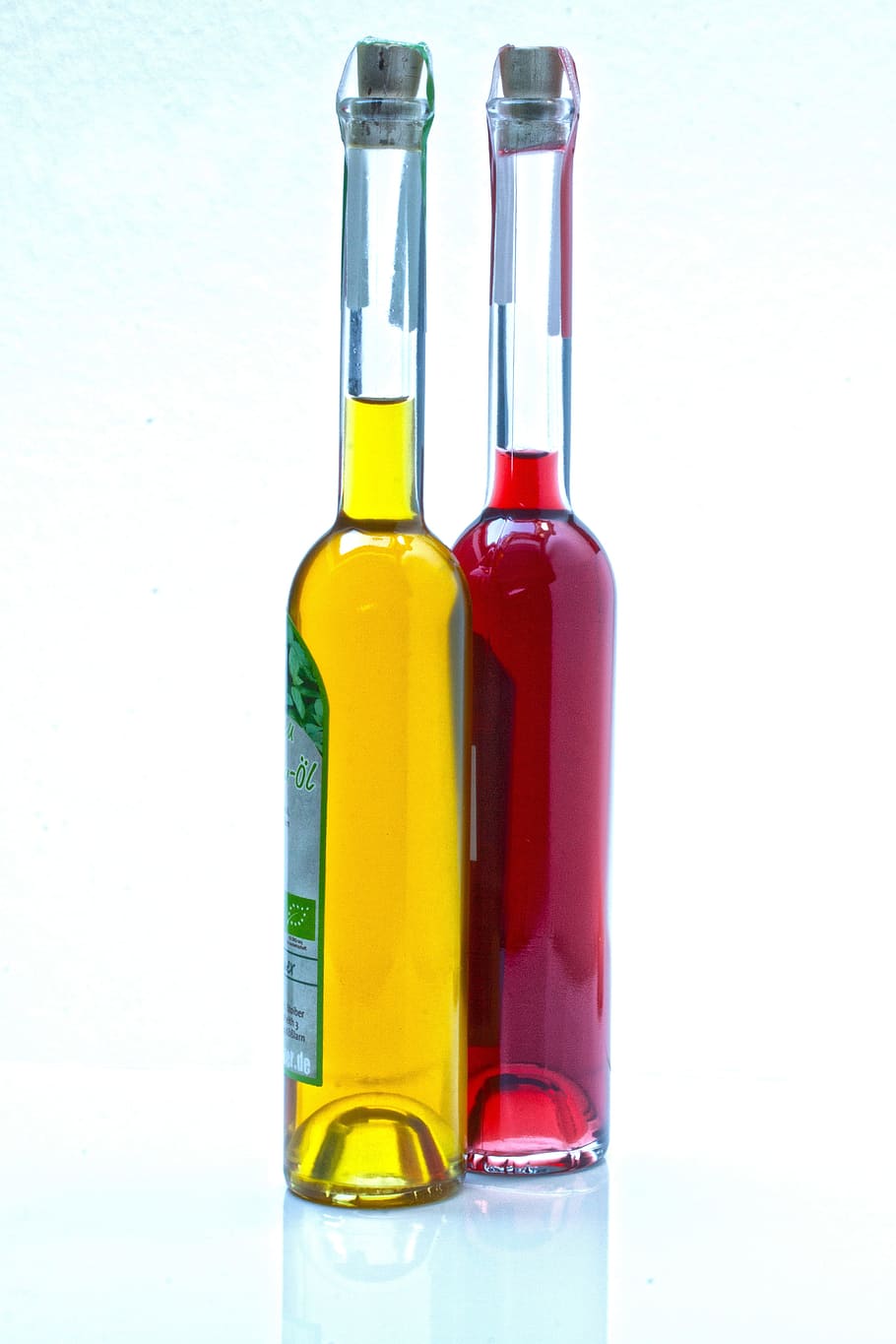 two, green, labeled, glass bottles, filled, yellow, red, liquids, Aceto, Raspberry Vinegar