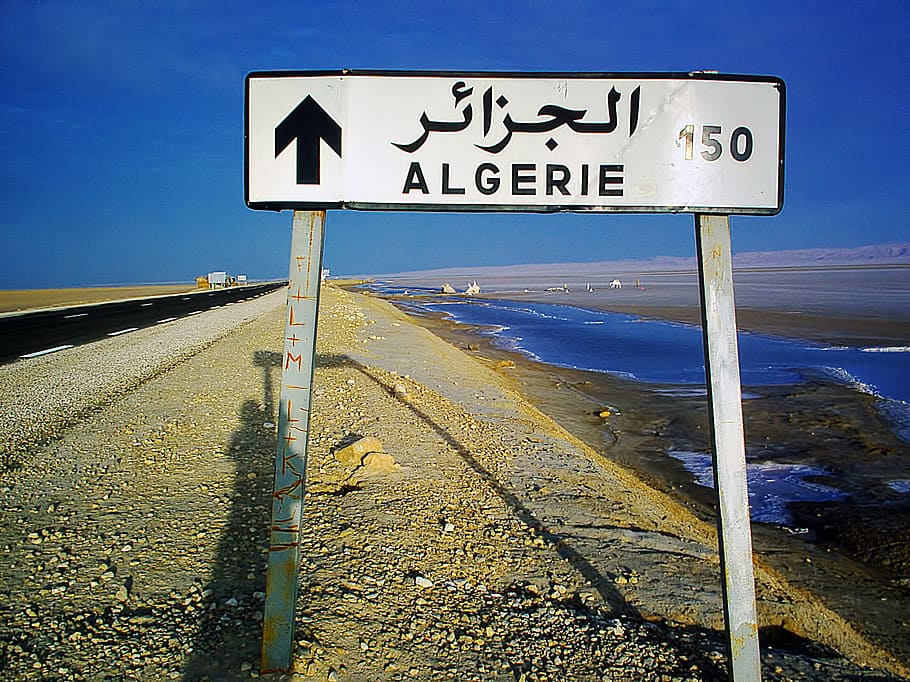 algiers, algeria road sign, daytime, signpost, algeria, 150 km, road, salt lake, dry, tunisia
