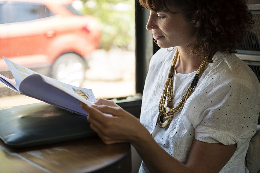 woman, wearing, white, scoop-neck t-shirt, book, break, cafe, coffee shop, hangout, leisure