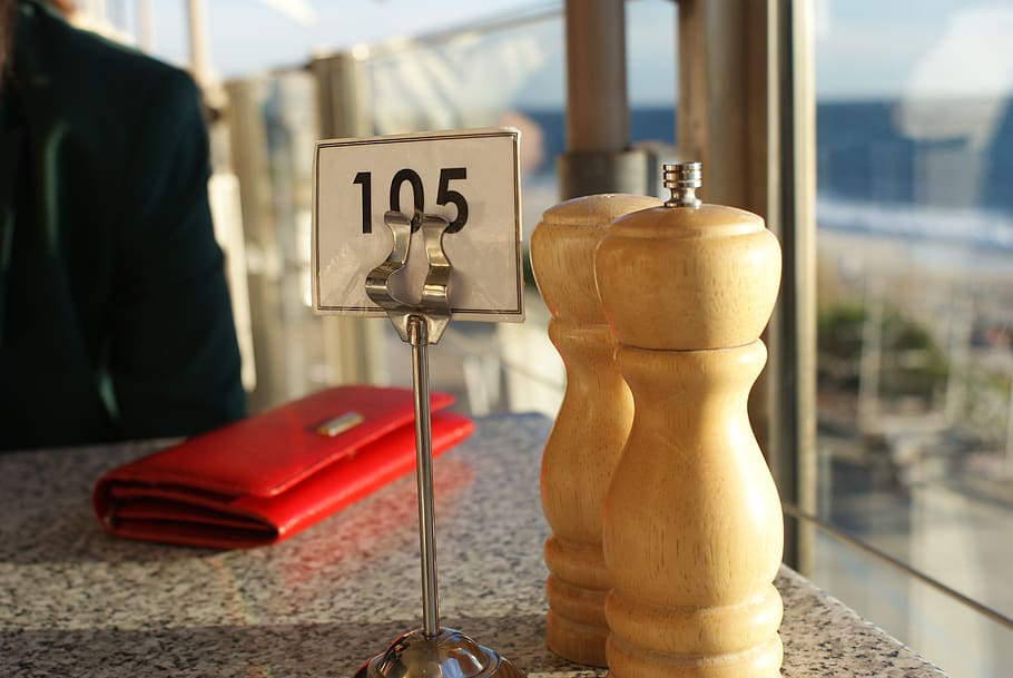 salt and pepper shakers, seaside, table, dining, ocean, restaurant, outdoor, view, focus on foreground, day