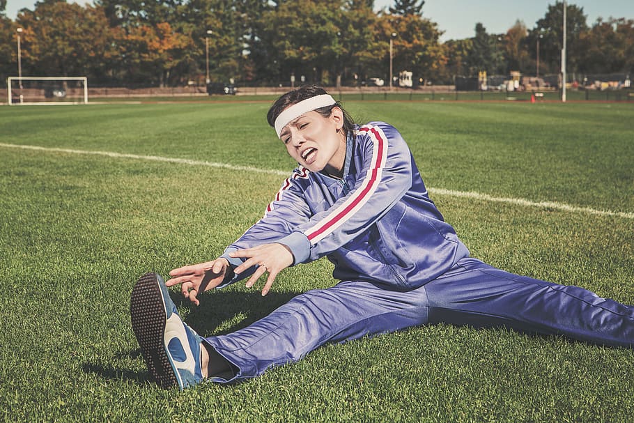 stretching, tracksuit, track and field, sports, athlete, fitness, shoes, headband, grass, field