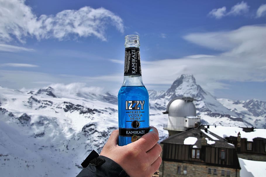 person, holds, izzy bottle, the alps, matterhorn, alcohol, banned, snow, in moscow, cold