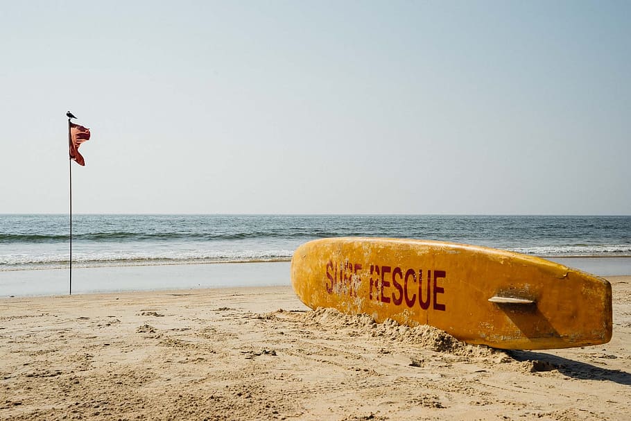 brown, surf rescue surfboard, flag pole, india, goa, beach, rescue, flag, sand, sea