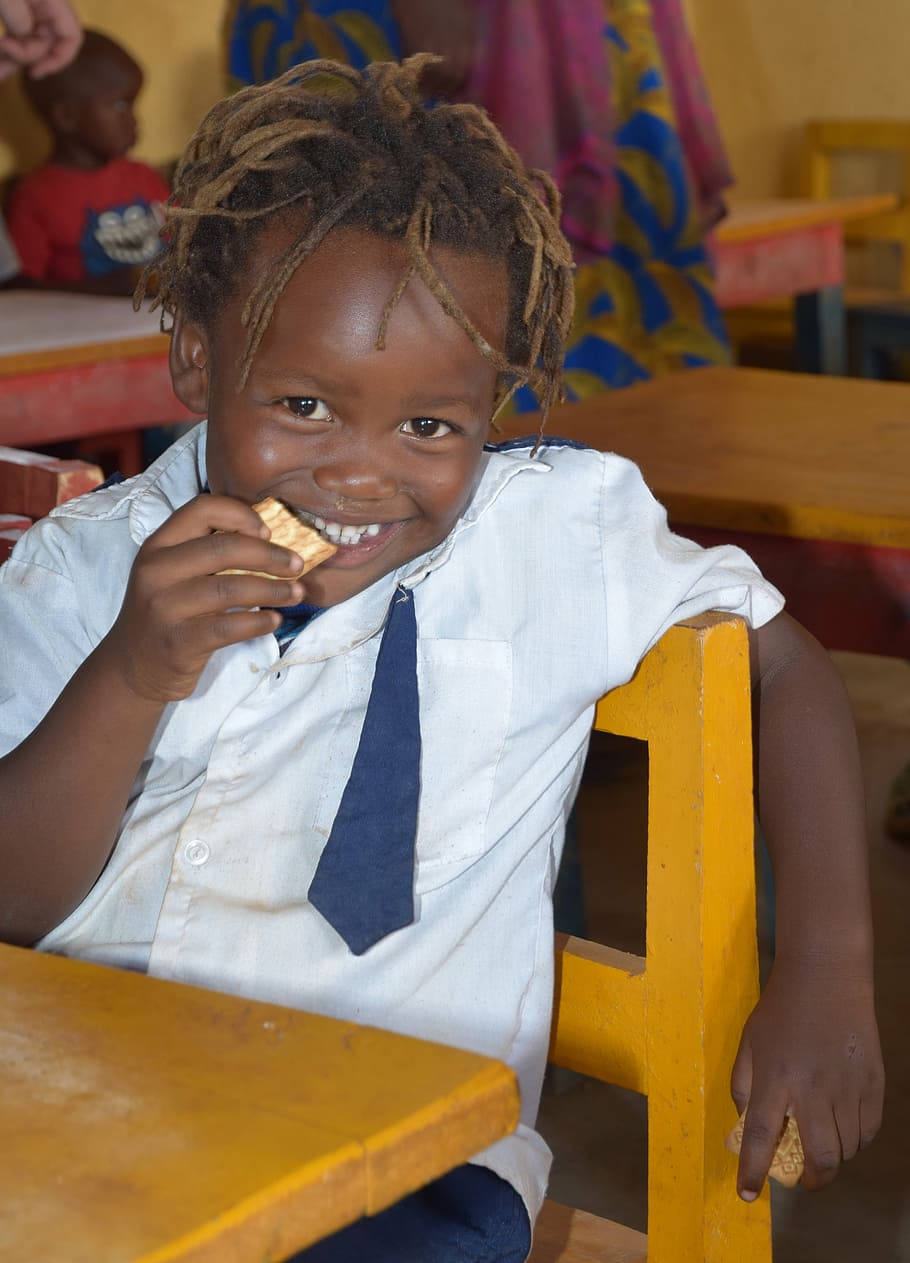 boy, sitting, chair, eating, biscuit, africa, rwanda, little girl, smile, laugh