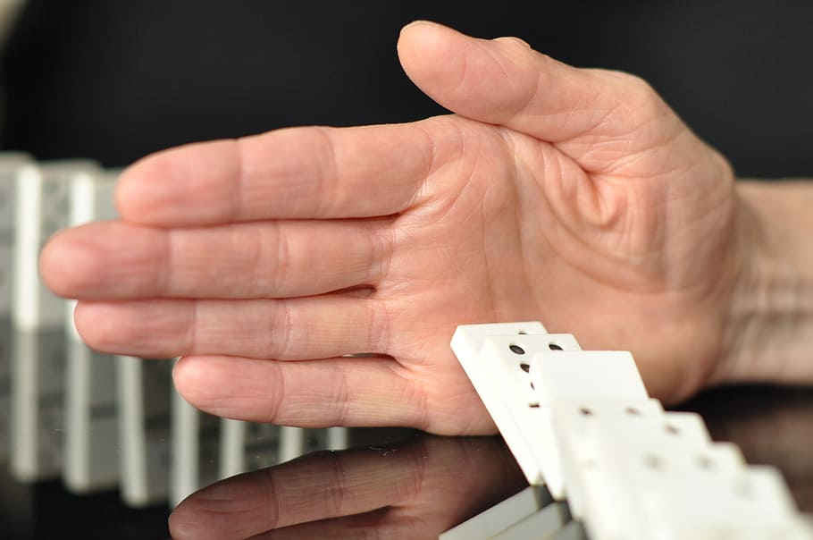 man playing dominoes, domino, game, corruption, business, human hand, hand, human body part, close-up, holding