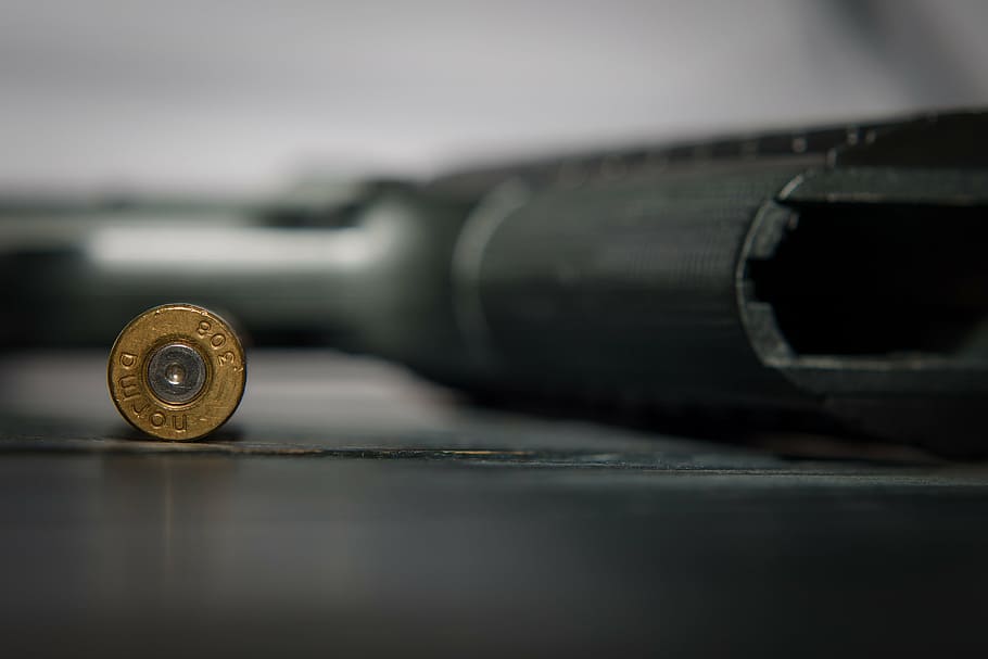 close-up photo, round, brown, bolt, ammunition, pistol, weapon, gun, close-up, military
