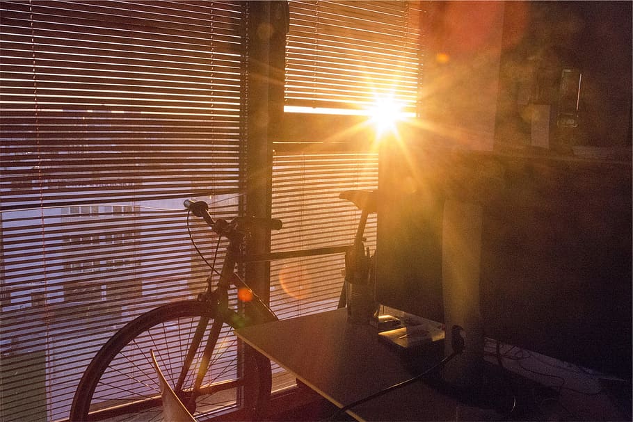 bike, glass window, desk, sunlight, window, blinds, bicycle, room, sunrise, sunbeam