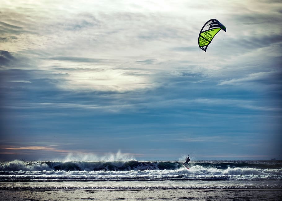 person surfing, ocean waves, daytime, close, green, black, kite, sky, vacation, summer