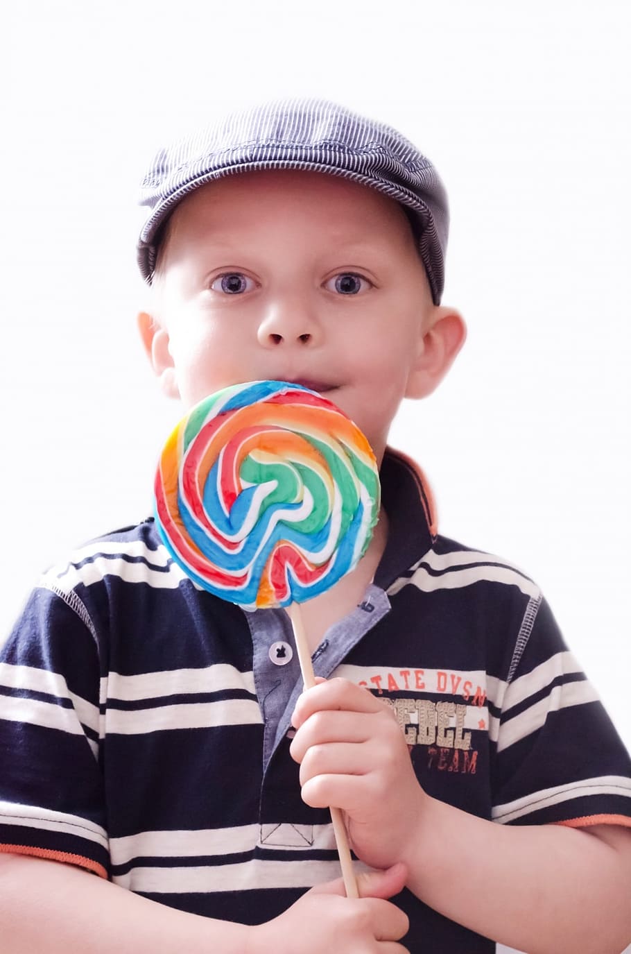 boy, wearing, black, white, striped, polo shirt, holding, lollipop, child, kid