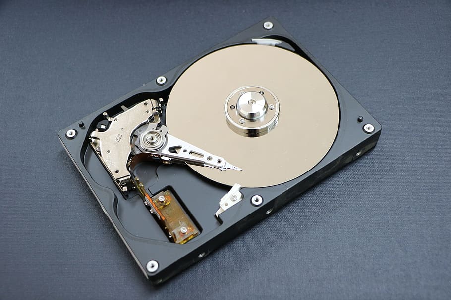 black, silver cd lens, surface, hard disk, a hard disk drive, an auxiliary storage device, storage devices, computer, storage, machine