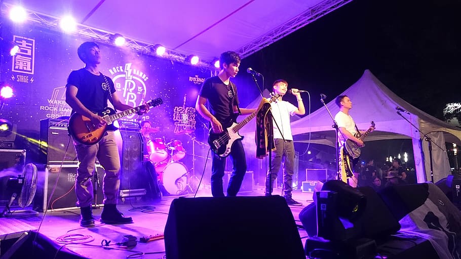 band, playing, music, stage, night time, orchestra, guitarist, bassist, singer, drummer