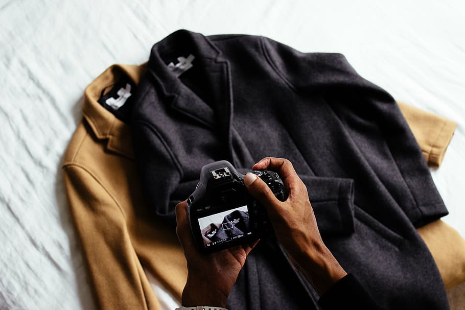 person, using, black, dslr camera, clothing, brown, jacket, coat, camera, hand