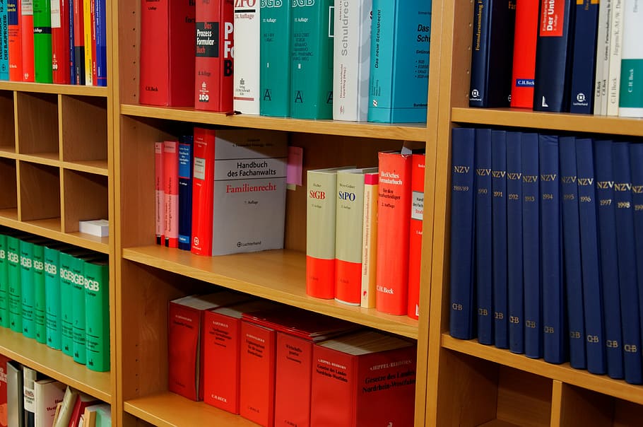 close-up photo, assorted, book display, shelf, bookcase, law firm, attorney, law books, regulation, paragraphs