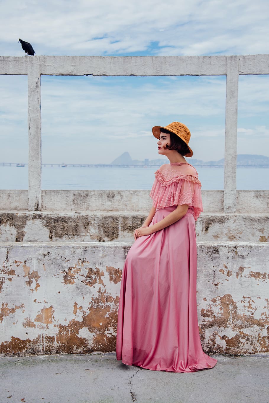 woman, pink, dress, standing, wall, daytime, floor, length, brown, hat