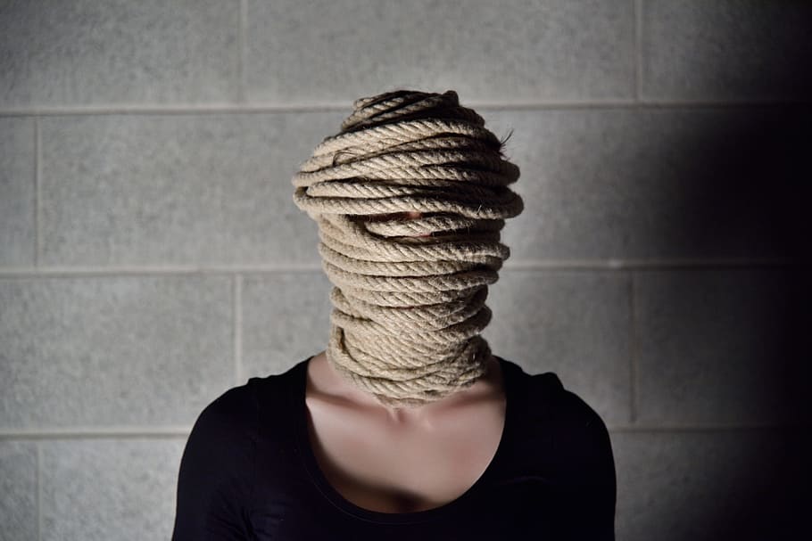 woman, black, scoop-neck, top, face, covered, brown, rope, woman in black, wall