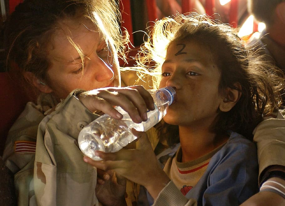 woman, helping, girl drinking water, plastic bottle, humanitarian aid, water, drink, assistance, help, soldier
