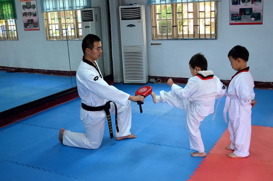 man, wearing, karate gi teaching child, kick, inside, training room, martial, arts, class, train
