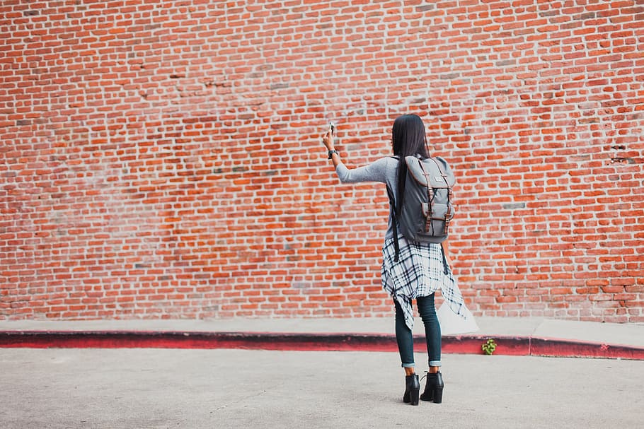 girl, wearing, backpack, standing, orange, brick wall, wall, bricks, back, woman
