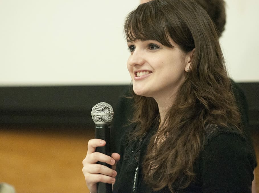 woman, wearing, black, jacket, holding, dynamic, microphone, dynamic microphone, anna chlopecki, lecturer