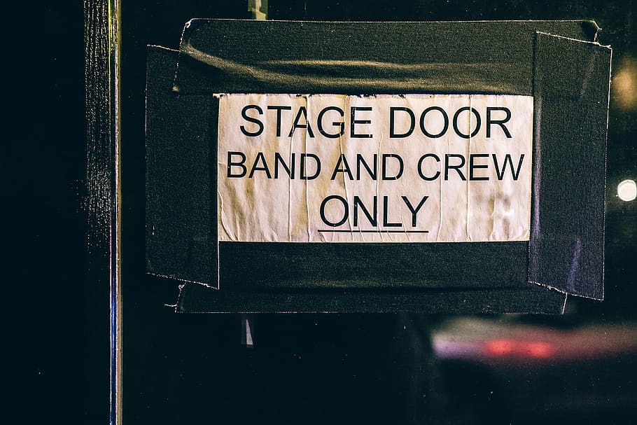 stage door band, crew, signage, sign, paper, stick, stage, band, message, post