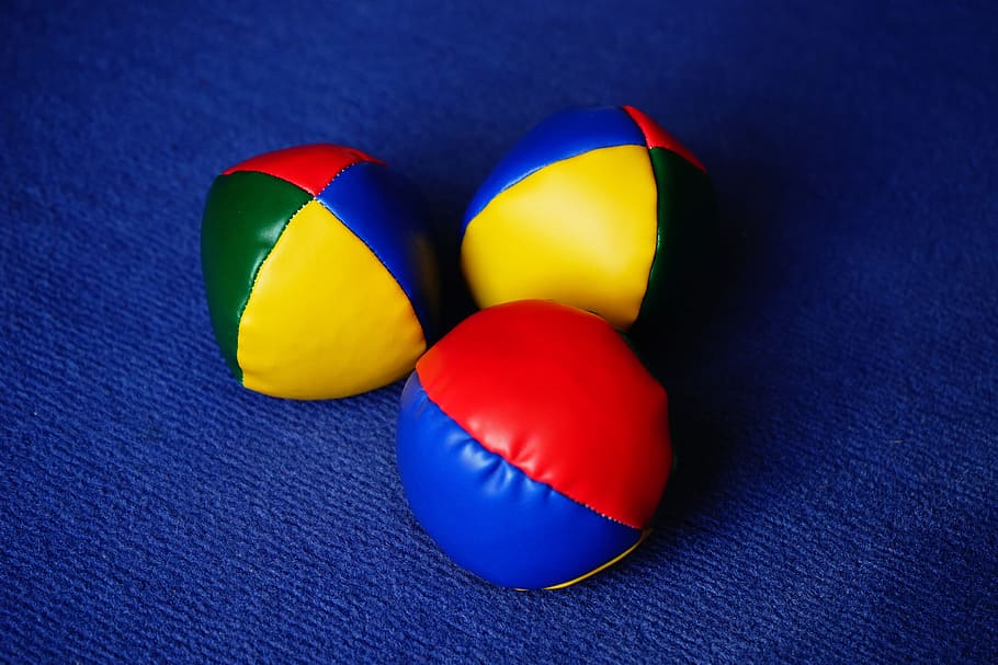 three, assorted-color ball decors, balls, juggling balls, juggle, colorful, color, yellow, red, blue