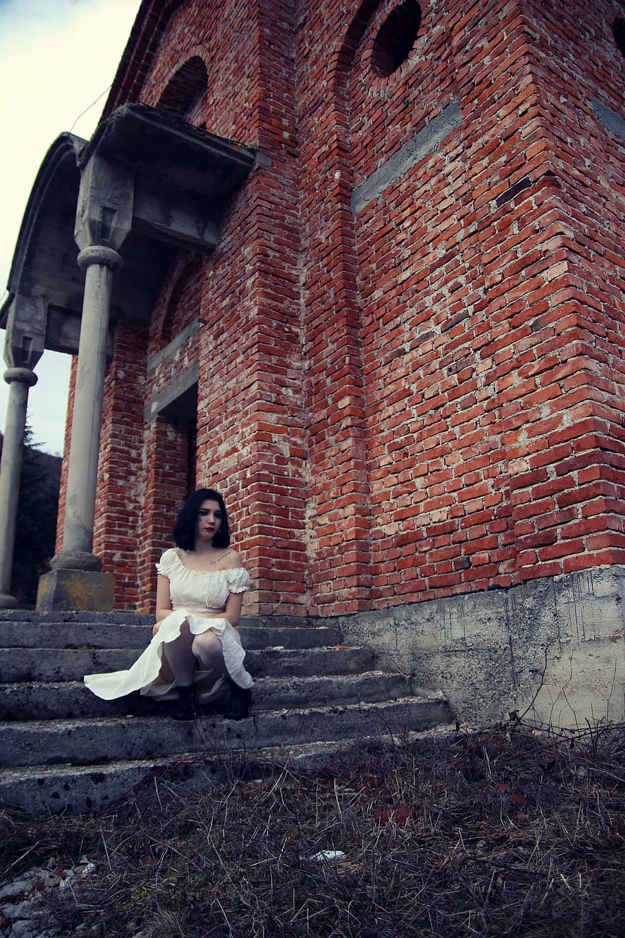 woman, wearing, off-shoulder dress, sitting, stair, brown, concrete, building, ghost, bride