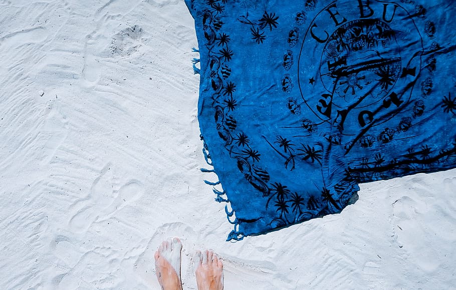 person, standing, blue, black, textile, white, sand, beach, shawl, picnic