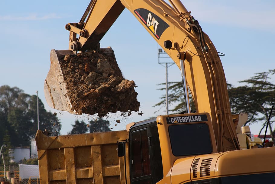 yellow, caterpillar excavator bucket, filled, soil, dump, truck, daytime, work, construction, machinery