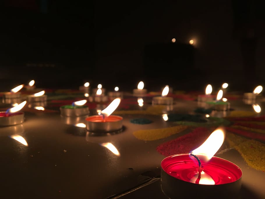 close-up photo, red, lighted, candles, flame, diwali, rangoli, joy, festive, burning