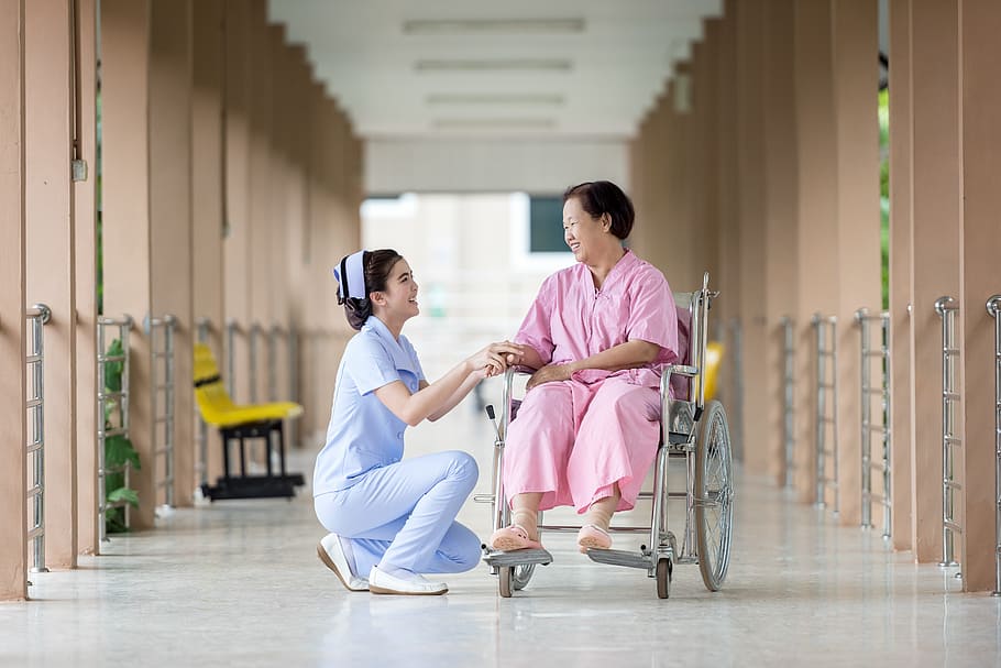 woman, pink, dress, sitting, wheel chair, hospital, assistance, care for, caretaker, talk