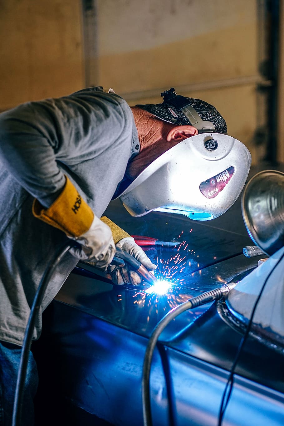man-welding-car-hood-people-man-work-welder-welding-metal-men