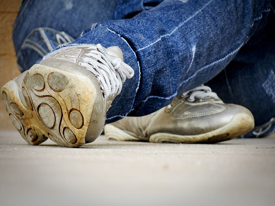 person, wearing, grey, sneakers, sitting, floor, shoes, runners, footwear, jeans