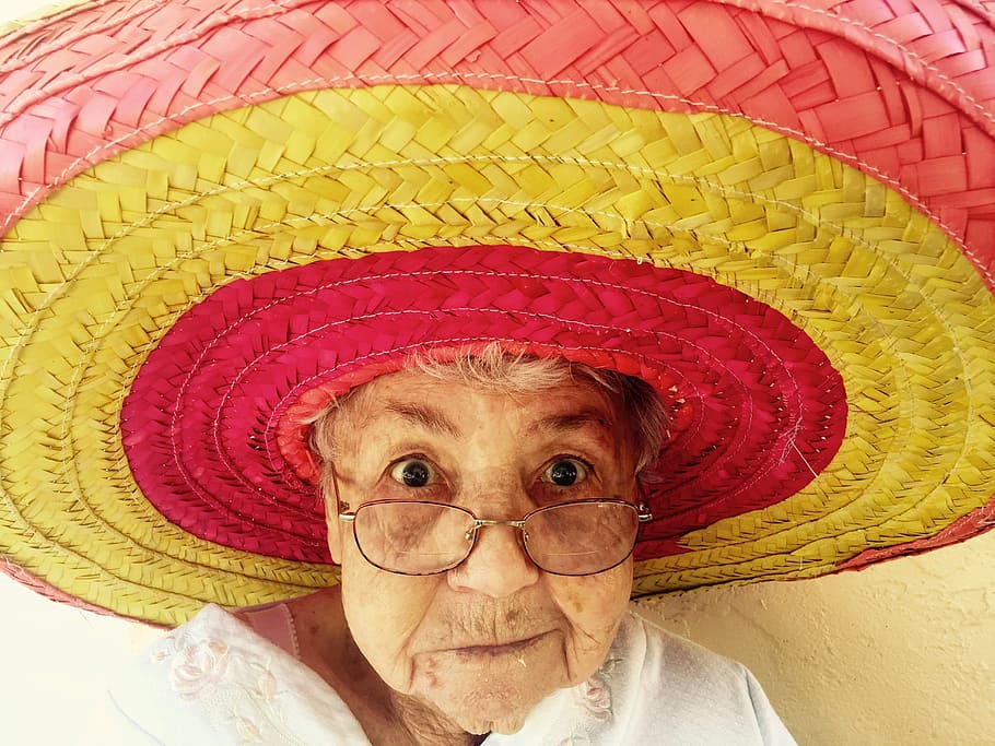 woman, wearing, red, yellow, straw hat, taking, selfie, sombrero, old woman, hat