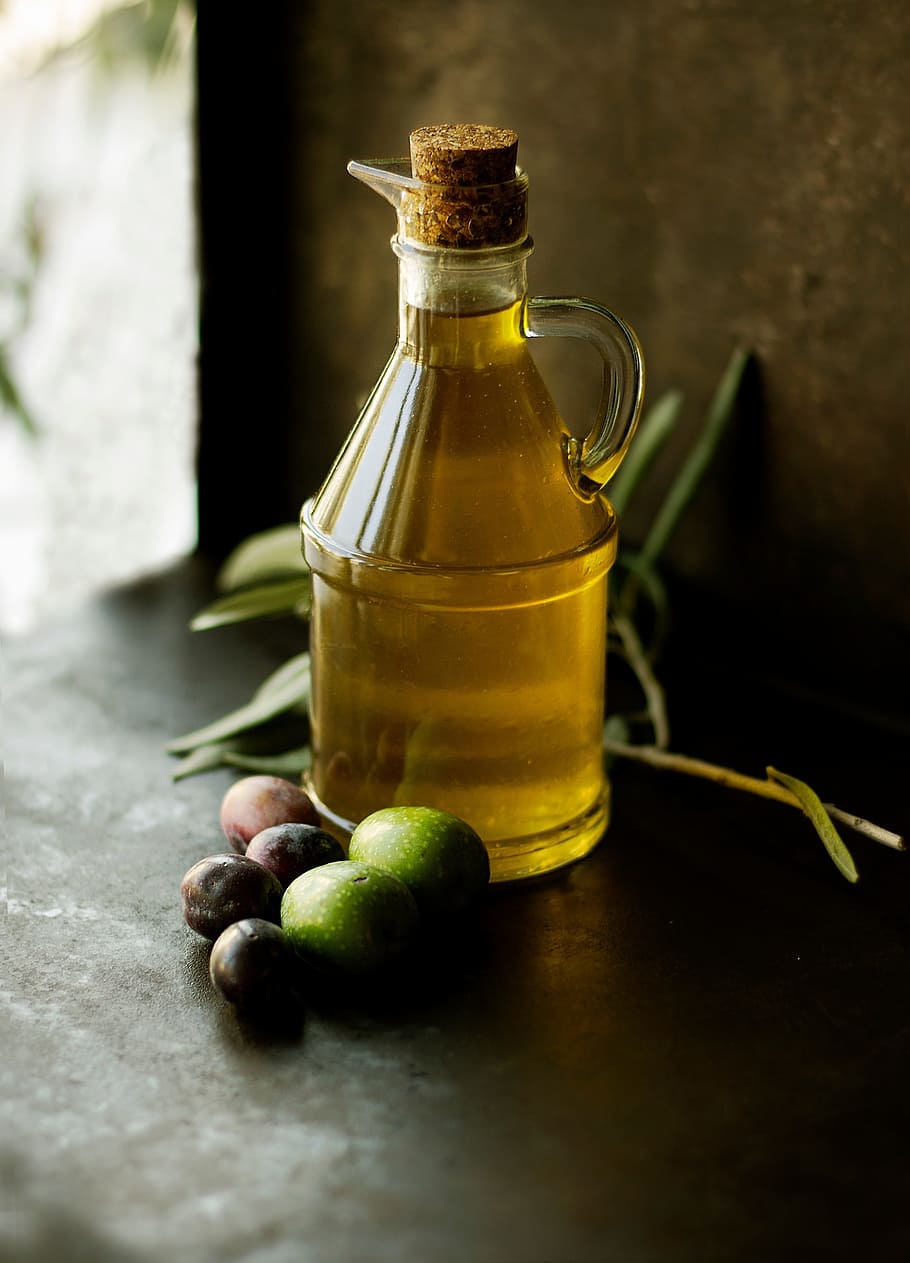 close-up photo, almost, full, glass bottle, black, surface, fruit, olive, oil, glass
