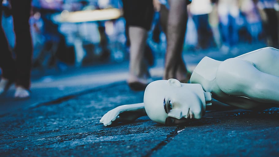 selective, focus photography, male, mannequin, lying down, street, dead, ignoring, uncaring, focus on foreground
