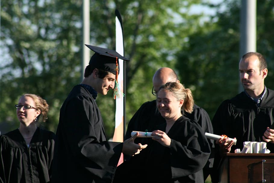 man holding certificate, graduation, secondary v, diploma, toga, group of people, young adult, adult, men, communication