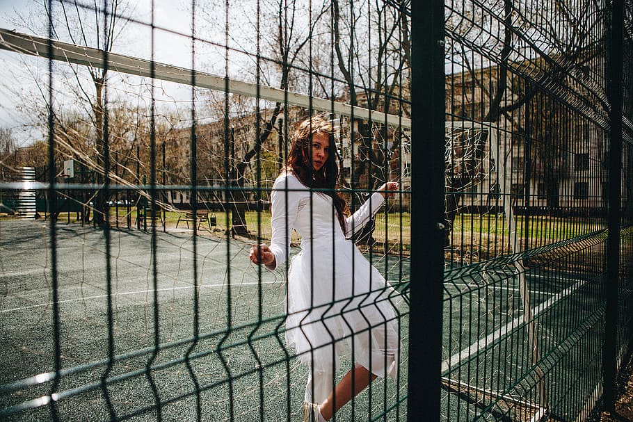 woman, white, long-sleeved, dress, sitting, soccer goal, net, daytime, Tennis Court, Girl