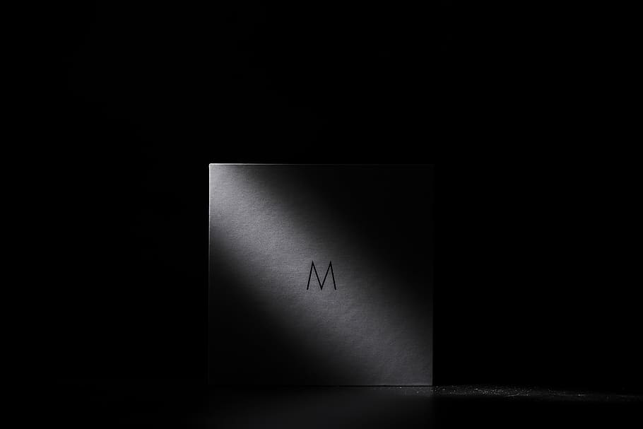 white, m-printed box, dimmed, room, dark, night, light, shadow, m, corner